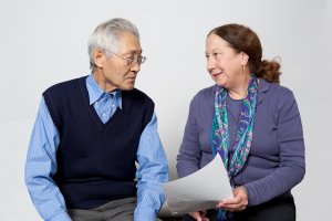 Information and Consultation specialist sitting with older man