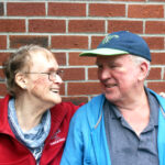 Annette and Michael, two members of the Springwell community, smiling at one another at a supportive housing site.