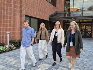 Four Springwell staff leaving the building to go for a walk